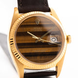 Closeup Photo of a Vintage Rolex Datejust 1601 Tiger Eye from 1974. 36mm with 18K yellow gold case, Tiger Eye stone dial, Automatic movement and Leather strap.