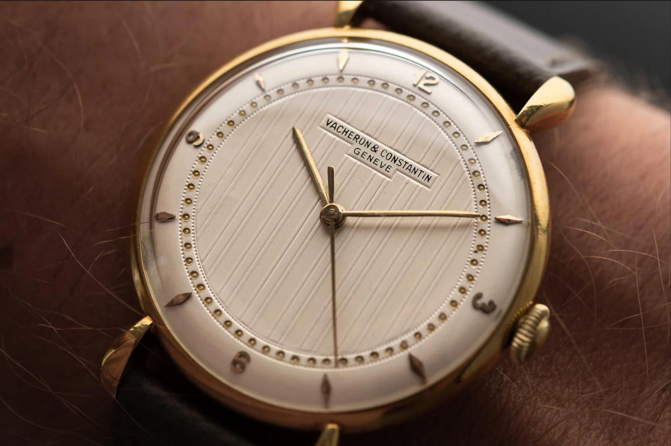 Gold Vacheron Constantin watch with leather strap.